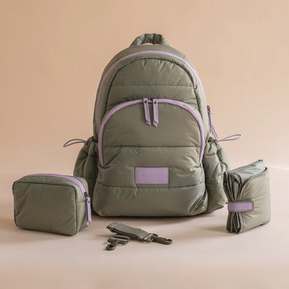 Green backpack with purple accents and matching pouches on a beige background