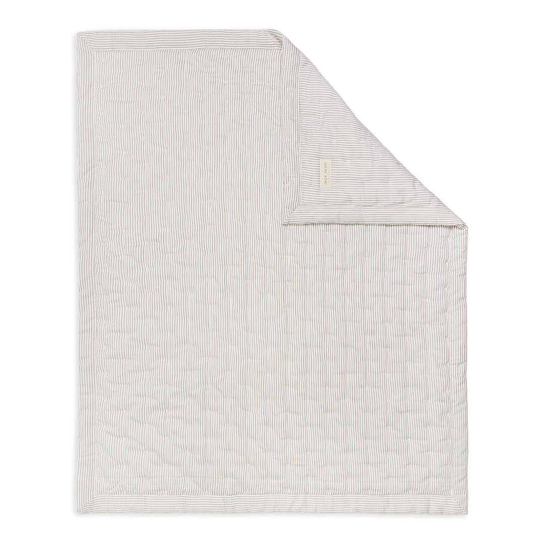 Textured blanket with a subtle pattern on a white background