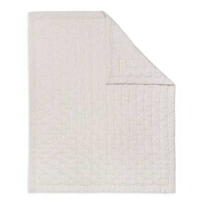 Textured blanket with a subtle pattern on a white background