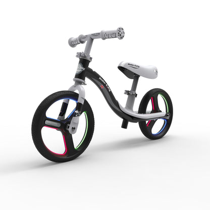 Children's balance bike with colorful wheels on a white background