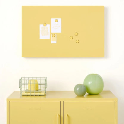 Yellow cabinet with decorative items against a white wall