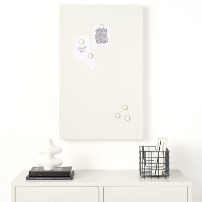 White cabinet with a whiteboard above it on a white wall.