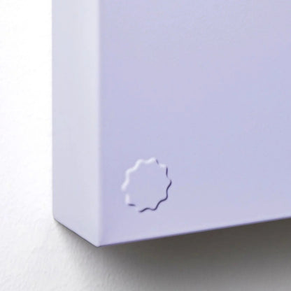 Close-up of a light purple product with a logo on a white background