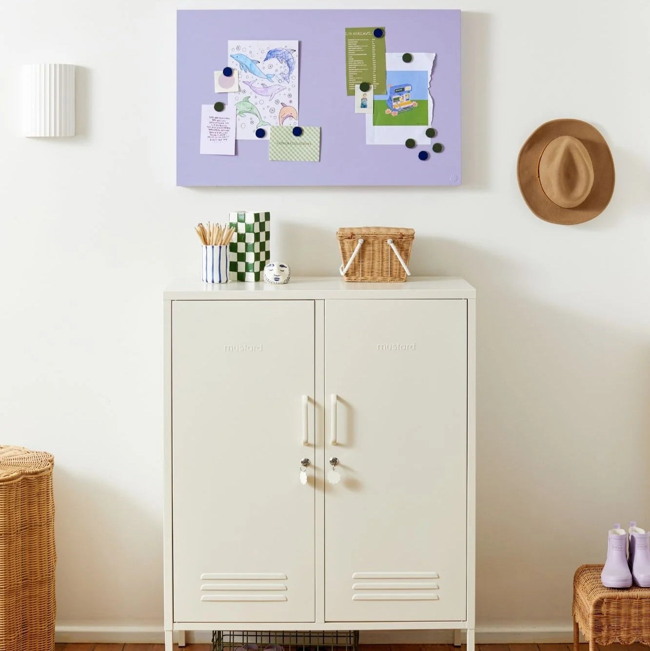 White cabinet with a purple bulletin board above it in a room setting.