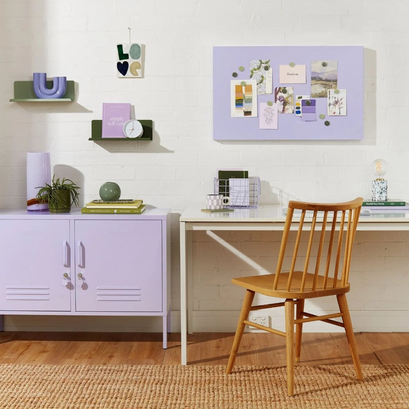 Home office with a wooden chair, desk, and lavender cabinets.