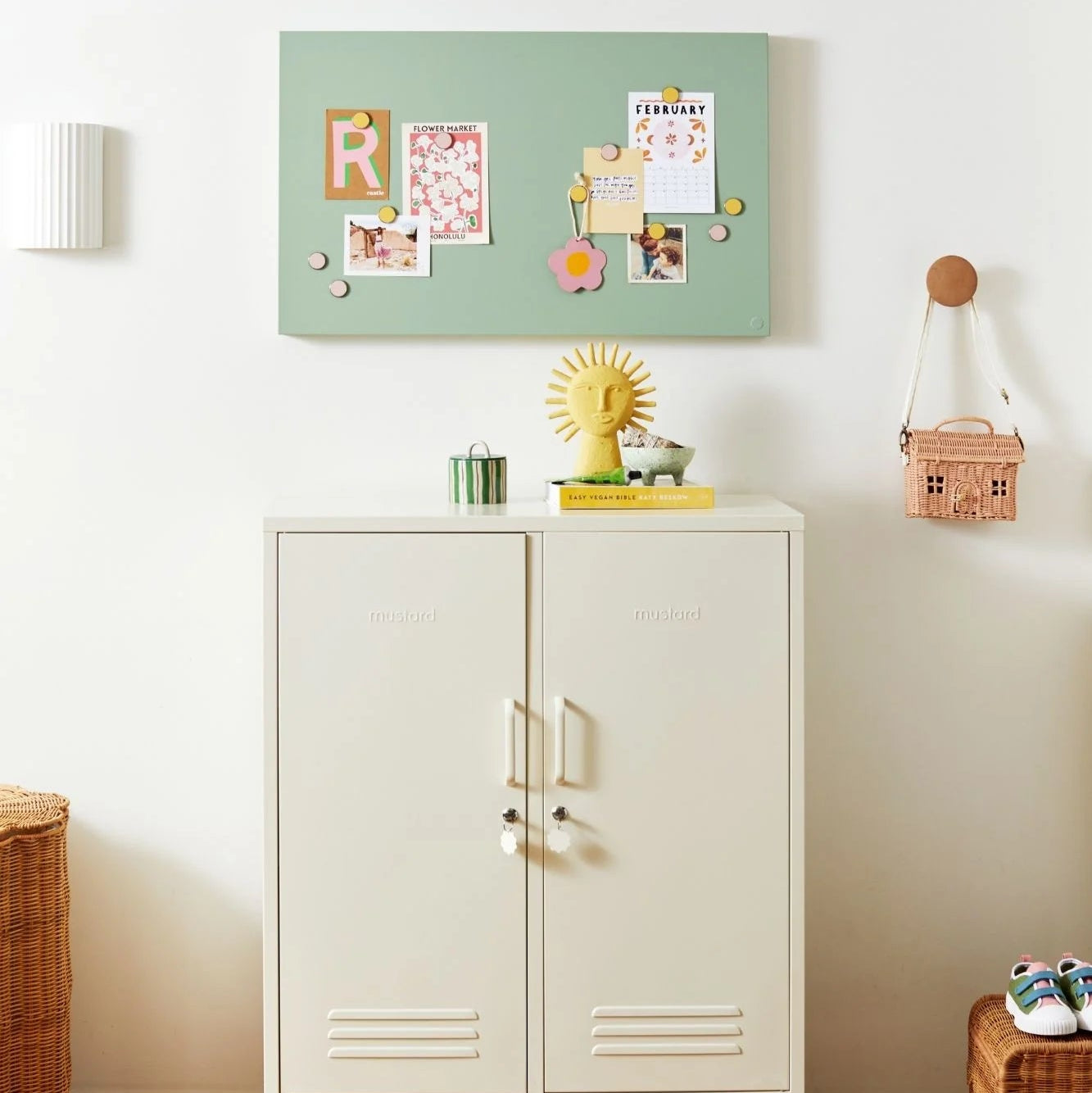 White cabinet with decorative items on a white wall