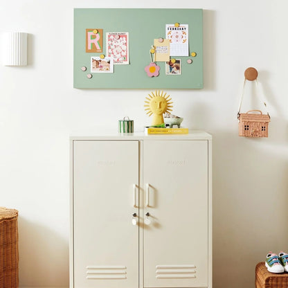 White cabinet with decorative items on a white wall