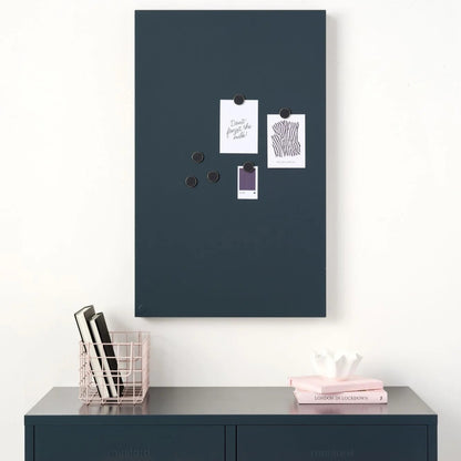 Navy magnetic board on a white wall above a navy locker.