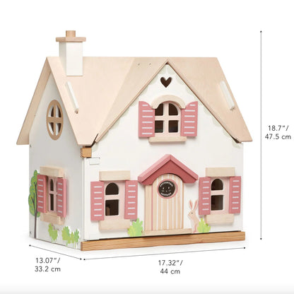 Small house-shaped toy with pink shutters and measurements on a white background