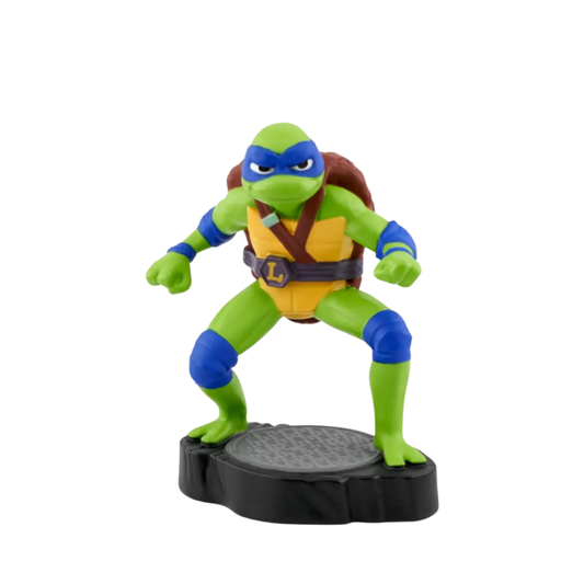Toy figure of a green turtle with blue accents on a white background