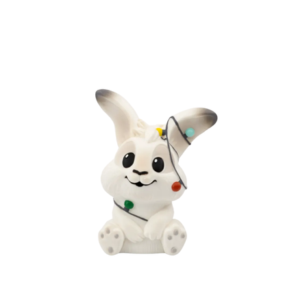 White rabbit figurine with black accents on a white background