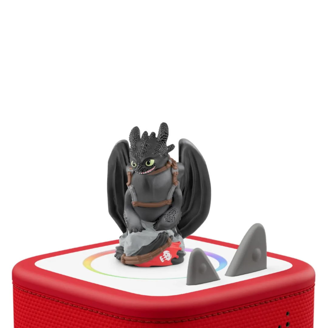 Toy figure of a dragon on a red and white base with shark fins