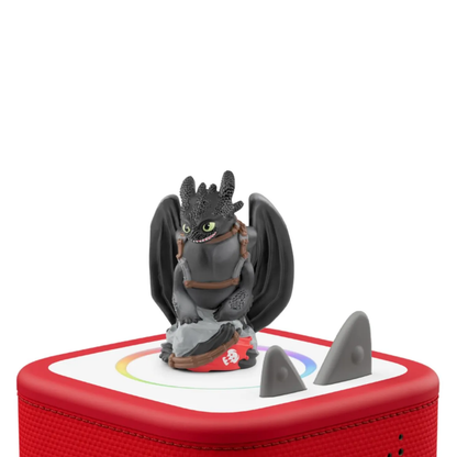 Toy figure of a dragon on a red and white base with shark fins