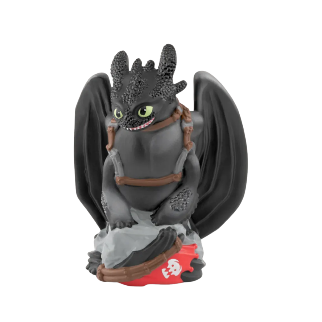 Toy dragon figure with black wings and a red base on a white background