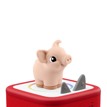 Toy pig on a red base with shark fin design on a white background