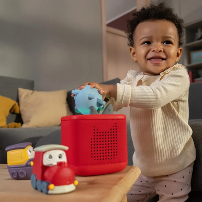 Child playing with toys on a table in a living room setting