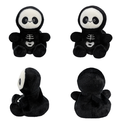 Set of four black and white skeleton plush toys on a white background