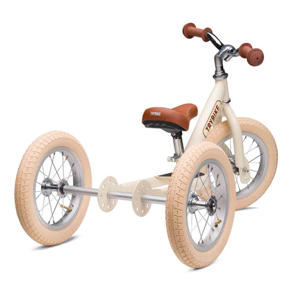 Children's tricycle with beige tires and brown seat on a white background
