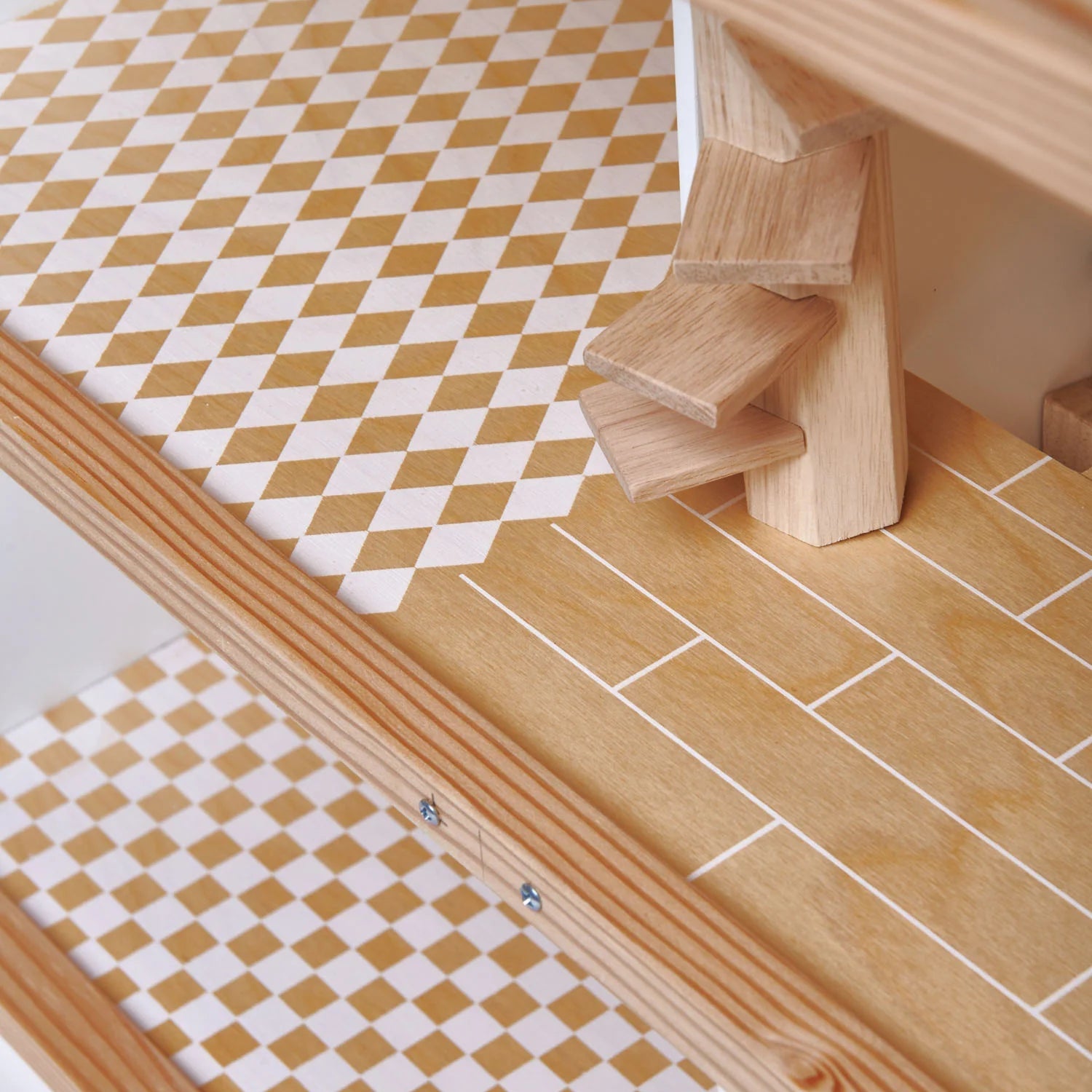 Wooden step stool with checkered mat on a tiled floor