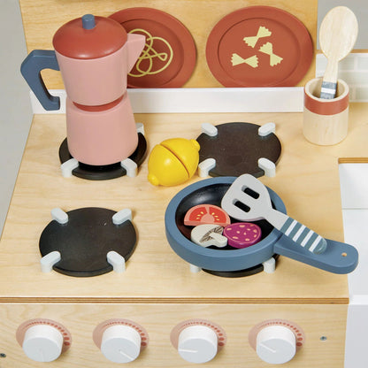 Wooden toy kitchen set with stove, pots, and utensils on a light background
