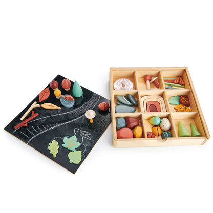 Colorful wooden toys in a box with a chalkboard and toys on it, featuring Junior Design Awards 2021 silver badge.