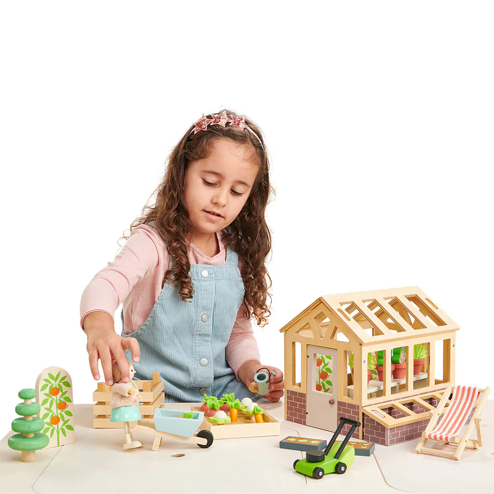 Young girl playing with a wooden toy set on a white background