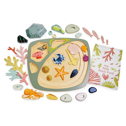 Children's toy set with sea-themed pieces and a book titled 'My Little Rock Pool' on a white background.
