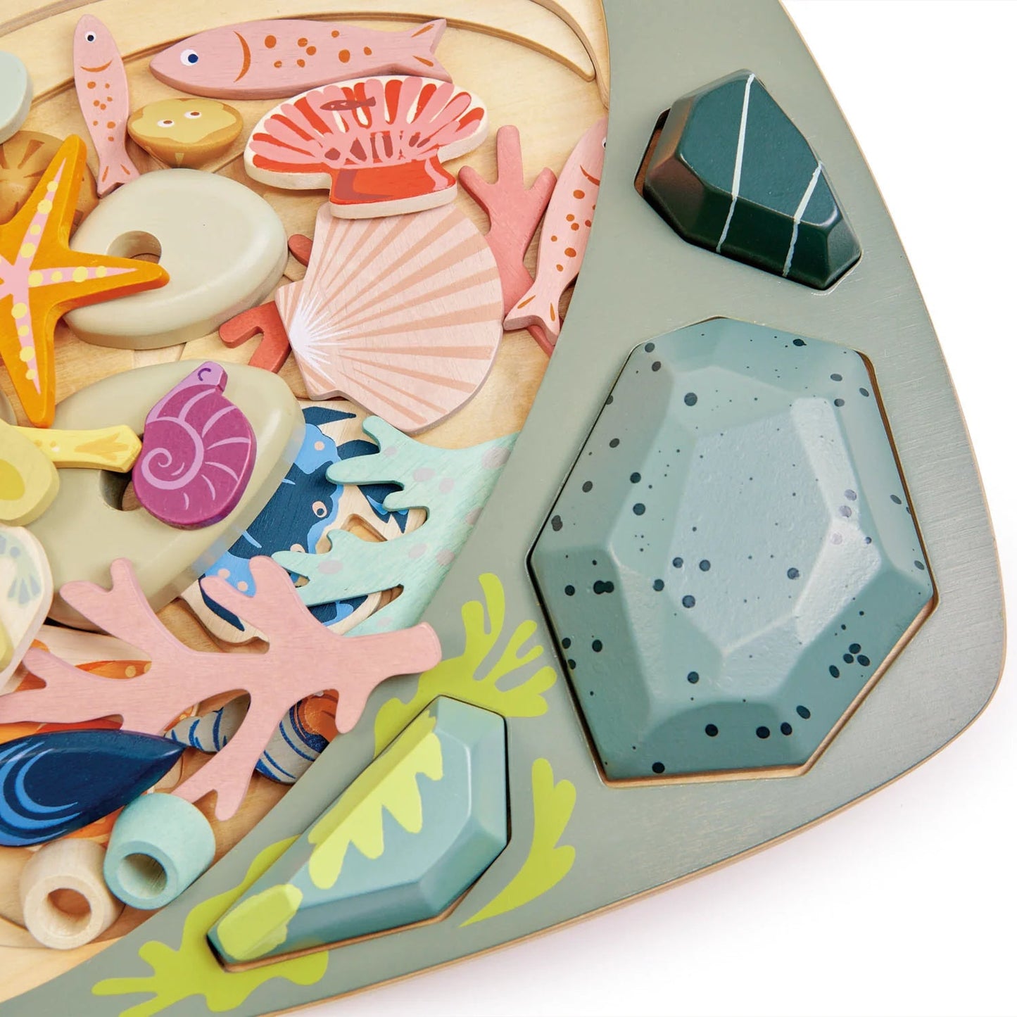 Colorful wooden sea-themed puzzle pieces on a wooden base