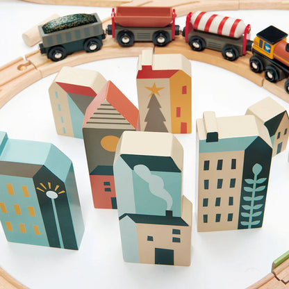 Wooden toy train set with colorful houses on a white background