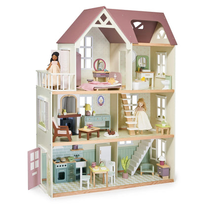 Dollhouse with multiple rooms and furniture on a white background