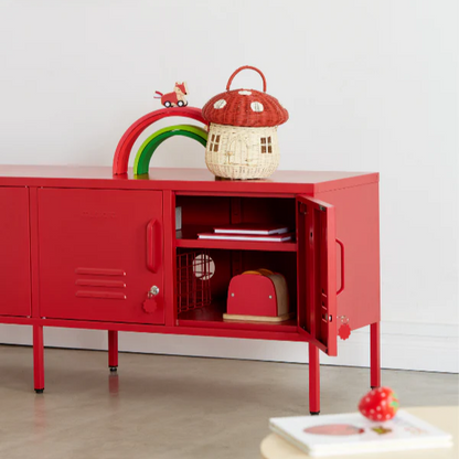 Red children's cabinet with open door, toys, and a colorful rainbow decoration in a room.