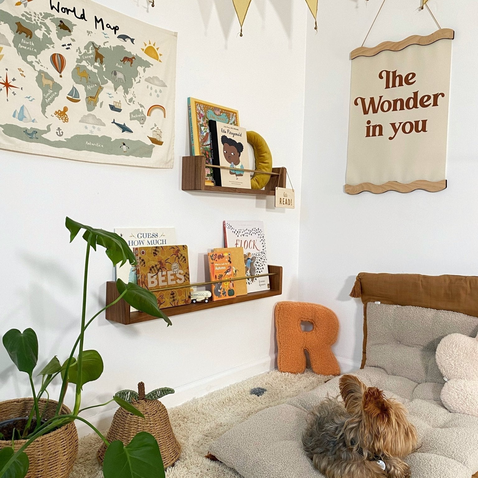 Children's room with world map, books, and decorative elements.