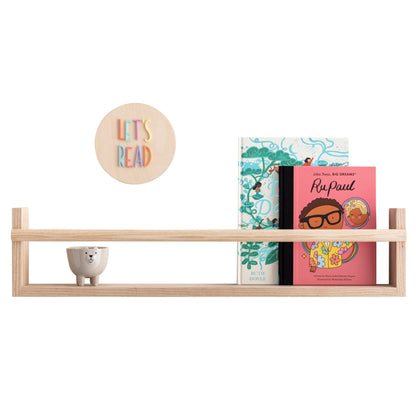 Wooden shelf with children's books and a decorative plate on a white background