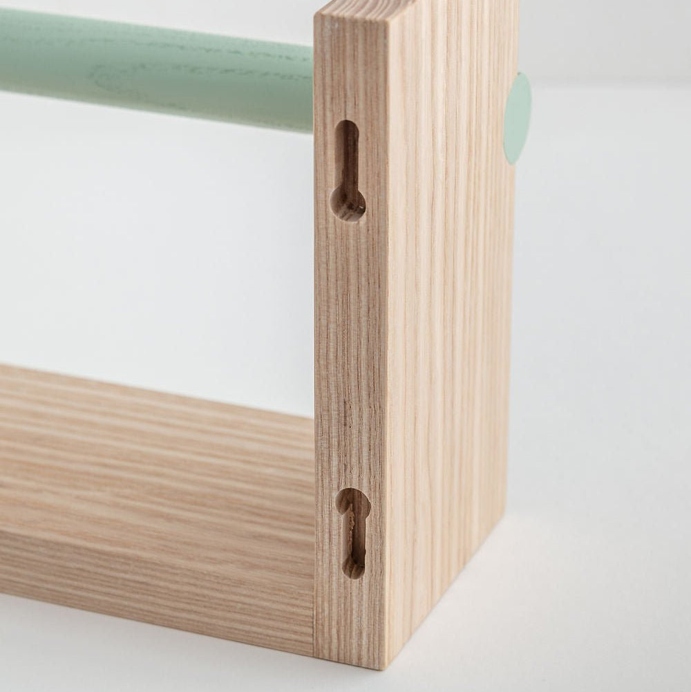 Close-up of a wooden shelf corner with a white background