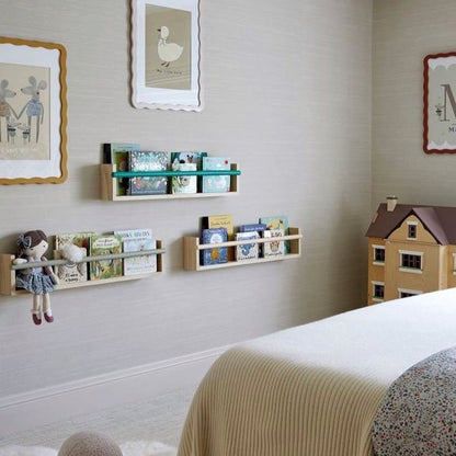 Children's room with shelves, toys, and wall art on a light gray wall.
