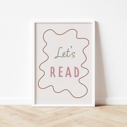 Framed poster with 'Let's Read' text on a white wall.