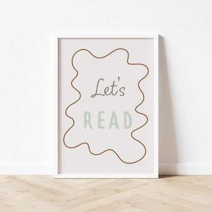 Framed poster with 'Let's Read' text on a white wall.