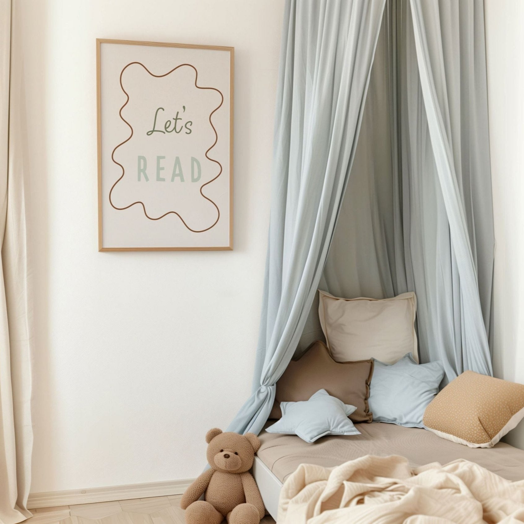 Children's reading nook with pillows, teddy bear, and framed 'Let's Read' sign.