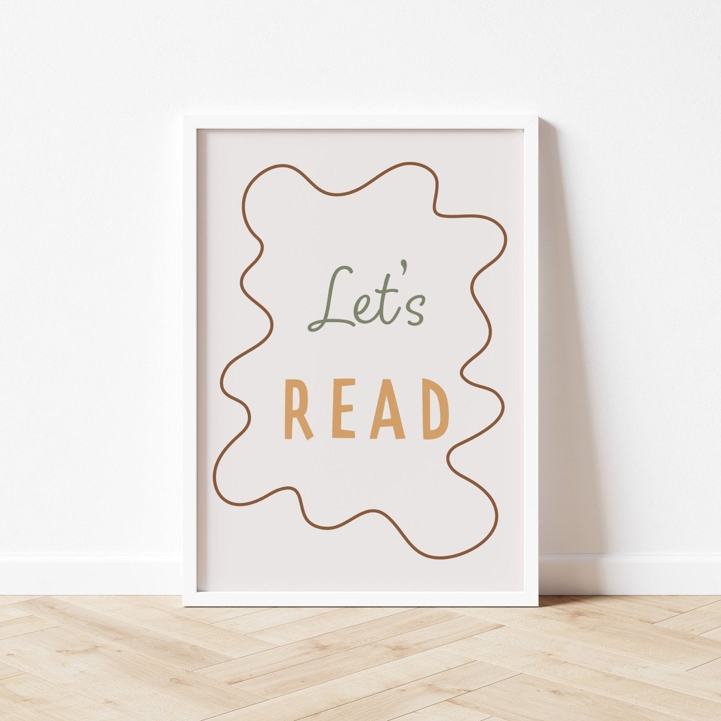 Framed poster with 'Let's Read' text on a white wall.