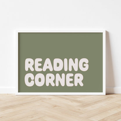 Framed sign with 'READING CORNER' text on a white wall.