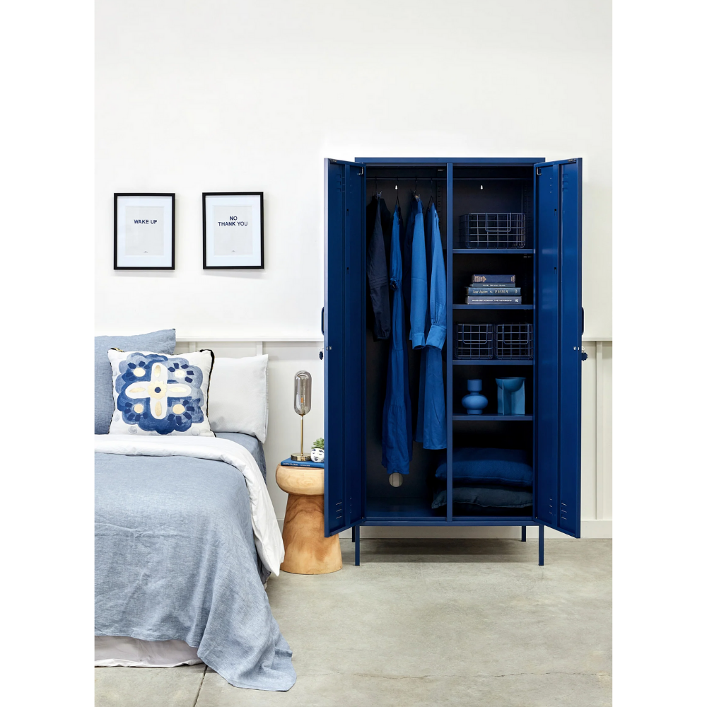 Blue wardrobe in a bedroom with bed and decor