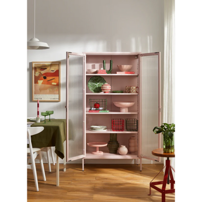 Pink cabinet with the door open in a dining room
