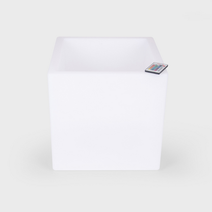 White LED light cube with remote control on a white background
