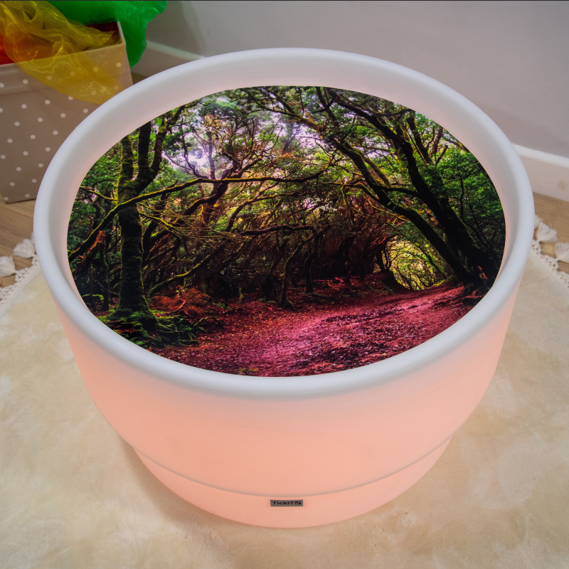 Round LED sensory table with nature-themed design on a white surface