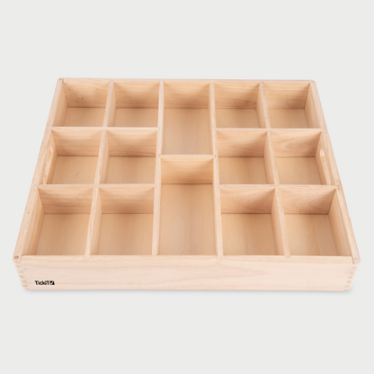 Wooden compartmentalized tray on a light gray background