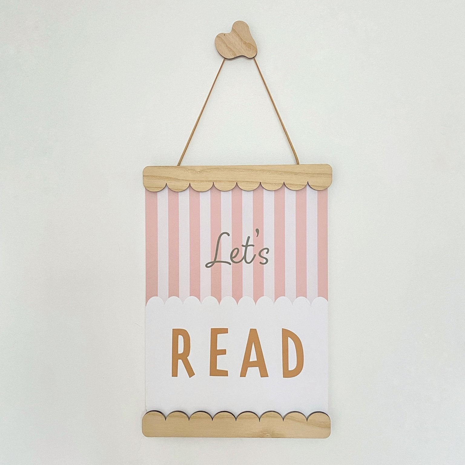 Decorative sign with 'Let's Read' text on a white background