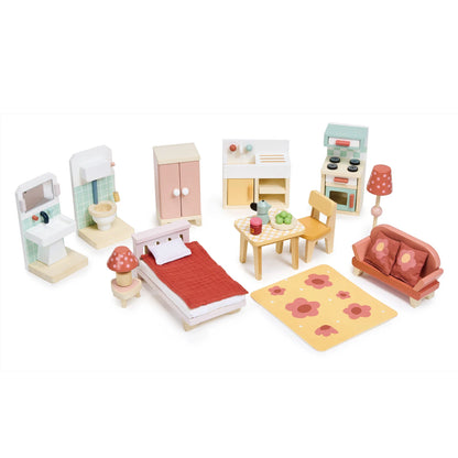 Set of wooden toy furniture including a bed, sofa, and kitchen on a white background