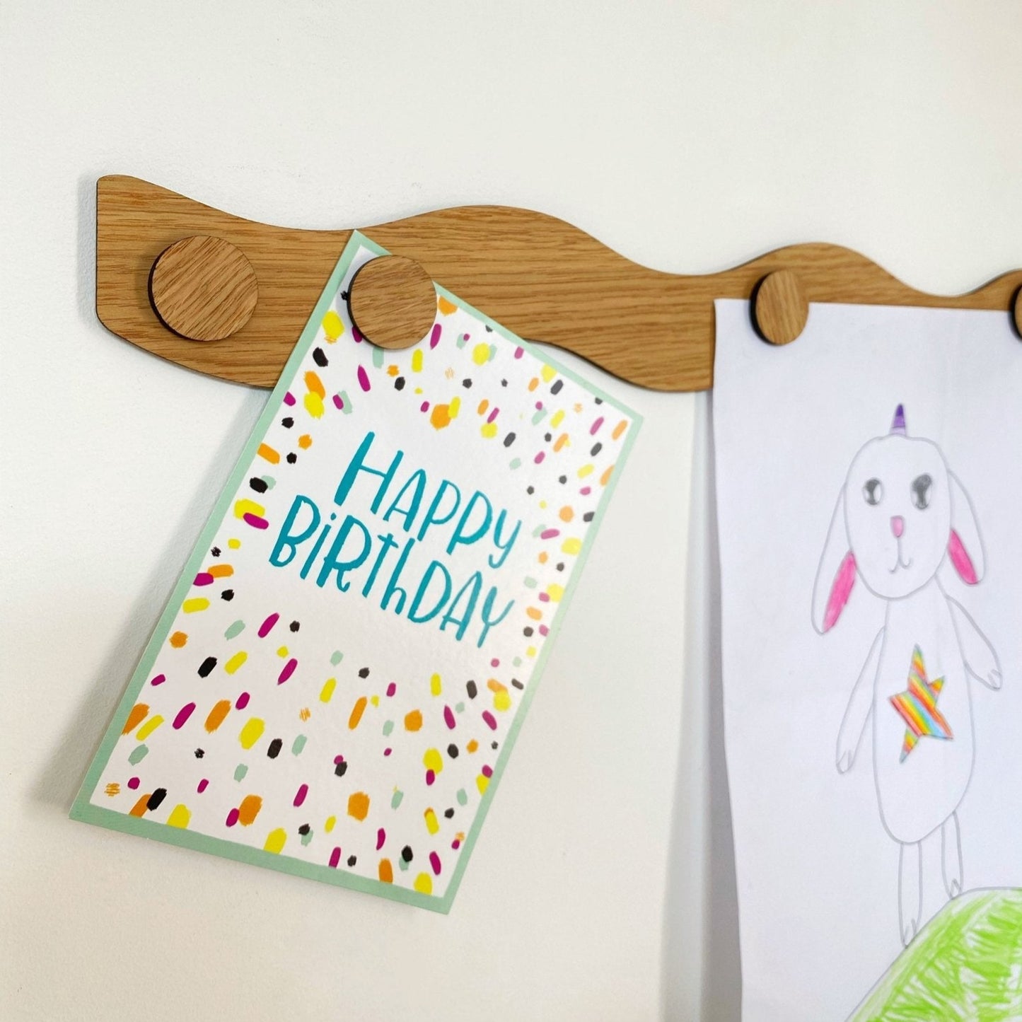 Happy Birthday card with colorful design on a wooden hanger