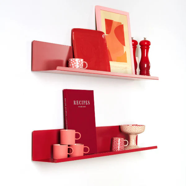 Red shelves with kitchen items on a white wall