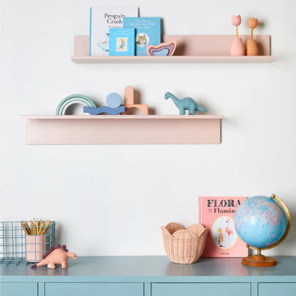 Children's room with shelves and cabinets, featuring toys and decor items.